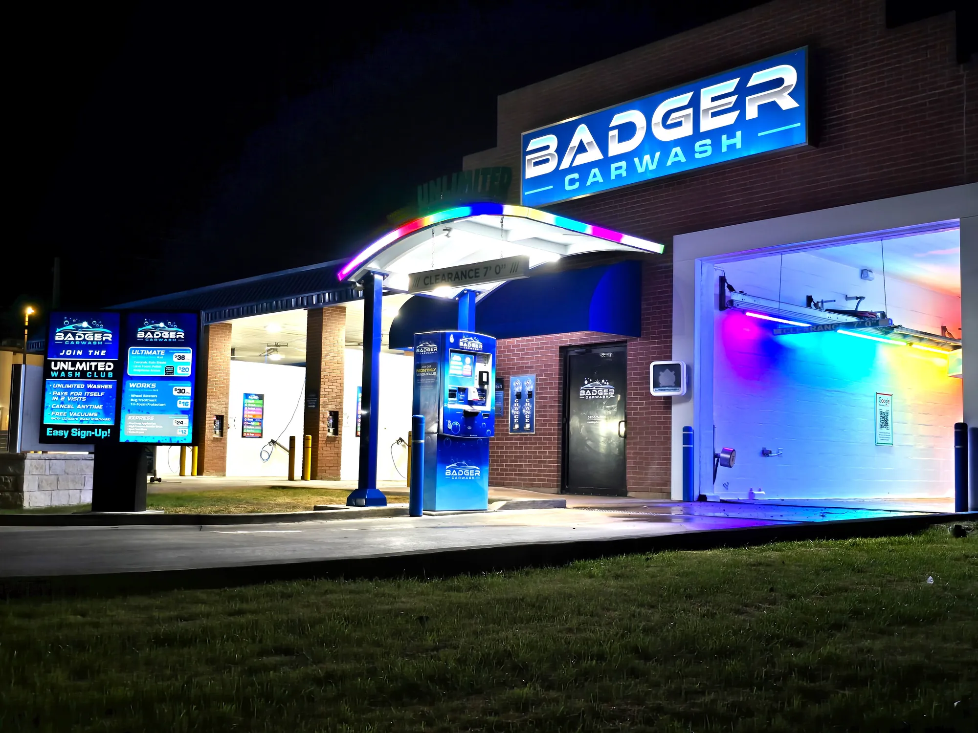 Badger Carwash automatic wash and self-serve bays illuminated at night in Lampasas